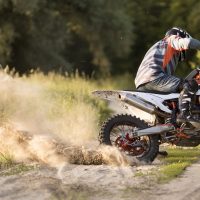 stylish-man-riding-motorbike-forrest